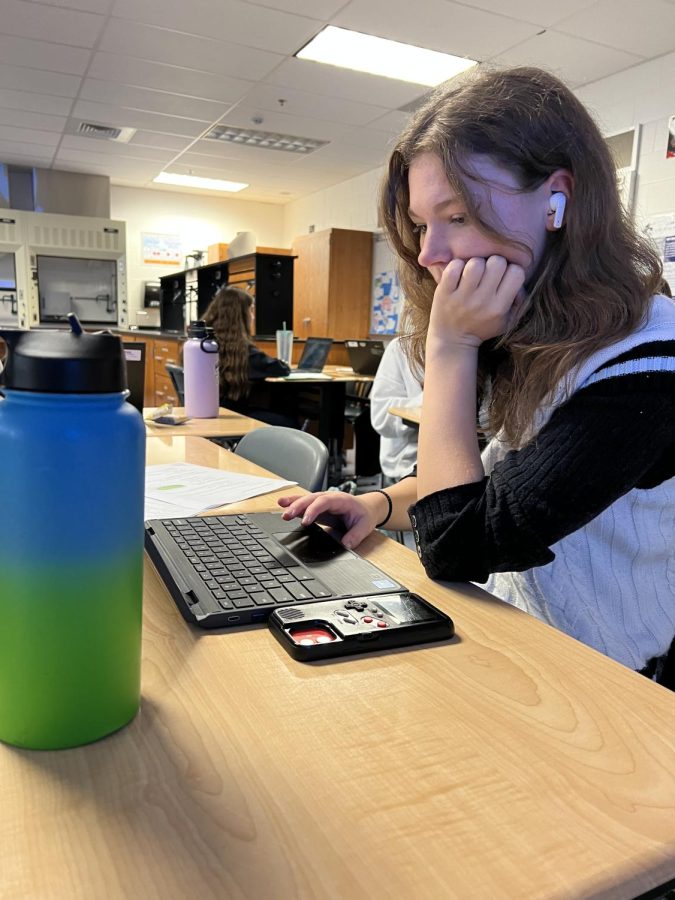 A John Champe student listening to music while doing work in biology class | Photo Courtesy Of Sasha Hoo