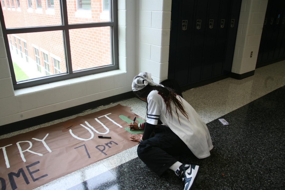 SCA Student Ayda Pannell is creating posters for the junior staircase which will be displayed during the spirit week class competition.