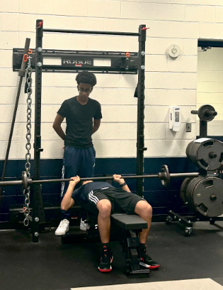 John Champe students lifting weights during Wrestling practice. 