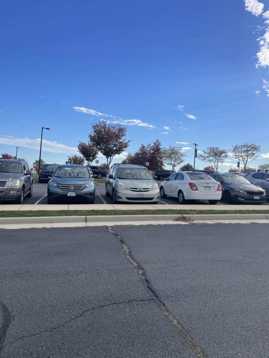 John Champe High Schools full front parking lot containing student and staff vehicles. More than 50% of Juniors and Seniors have commuted to school this year leaving a surplus of students that have overspent on gas.