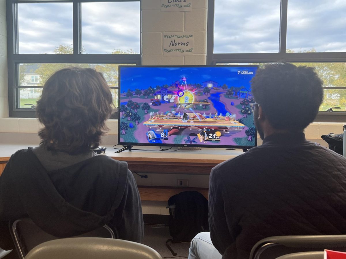 ESports team manager Zac Ellis, and Super Smash Brothers Ultimate team coach Michael Scott are working on strategies to provide for their teams’ players. Players are pictured practicing for their upcoming competition. 