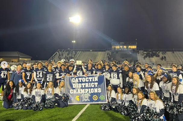 On Friday, November 3rd, the John Champe Varsity Football and Cheerleading team are holding the district champions banner on their home field. After the game against Freedom, they were named district winners for the 2023 season.