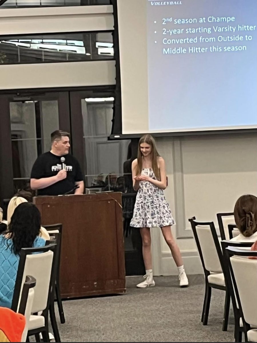 Varisity player Macy Farester recieving her varsity pin during the banquet.