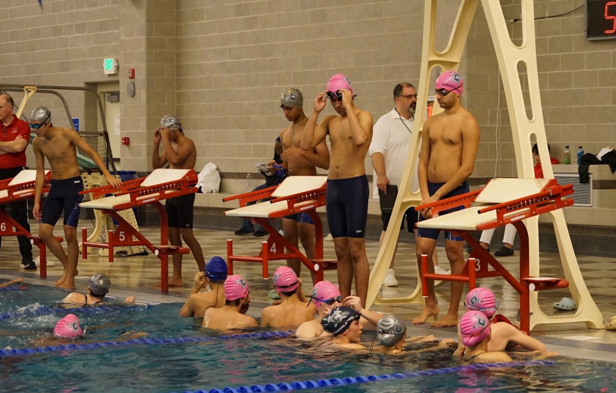 Members of the Champe Swim Team are warming up for their meet. Taken last month, the team was looking to continue their winning streak. 