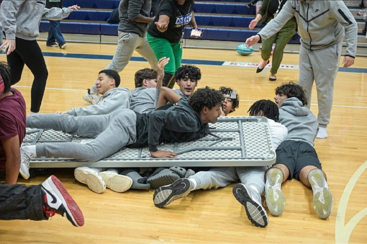 Table surf at the winter pep rally. Photo Courtesy of @champesca