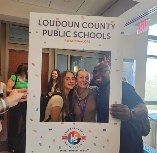 Students Liv Mcmann and Kyra Tellman posing with John Champe Principal Kevin Tyson at the Educators Rising Conference. This event lets students meet new people and overall learn lots of new information about the education field. 