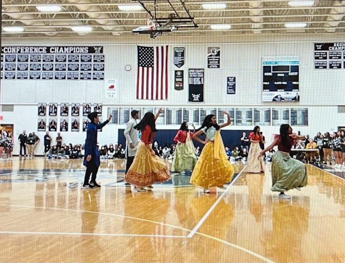 SASA performing a dance in cultural clothing at a Champe pep rally.