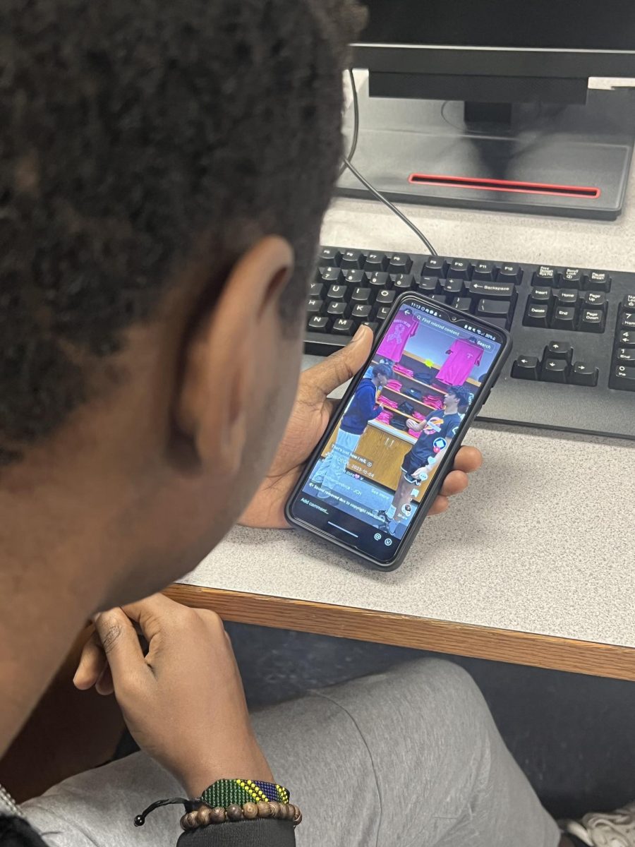 A student, Peter Kitula, viewing the TikTok page of Champe DECA after class. This TikTok, which was about the John Champe armory reached over 2,000 views.