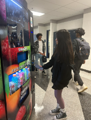 Parnika Palavalli buying a snack at the school vending machine. Previously she complained about prices being too high. 
