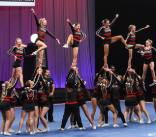  A picture of the Bomb Squad Cheer Team performing pyramids during competition. 