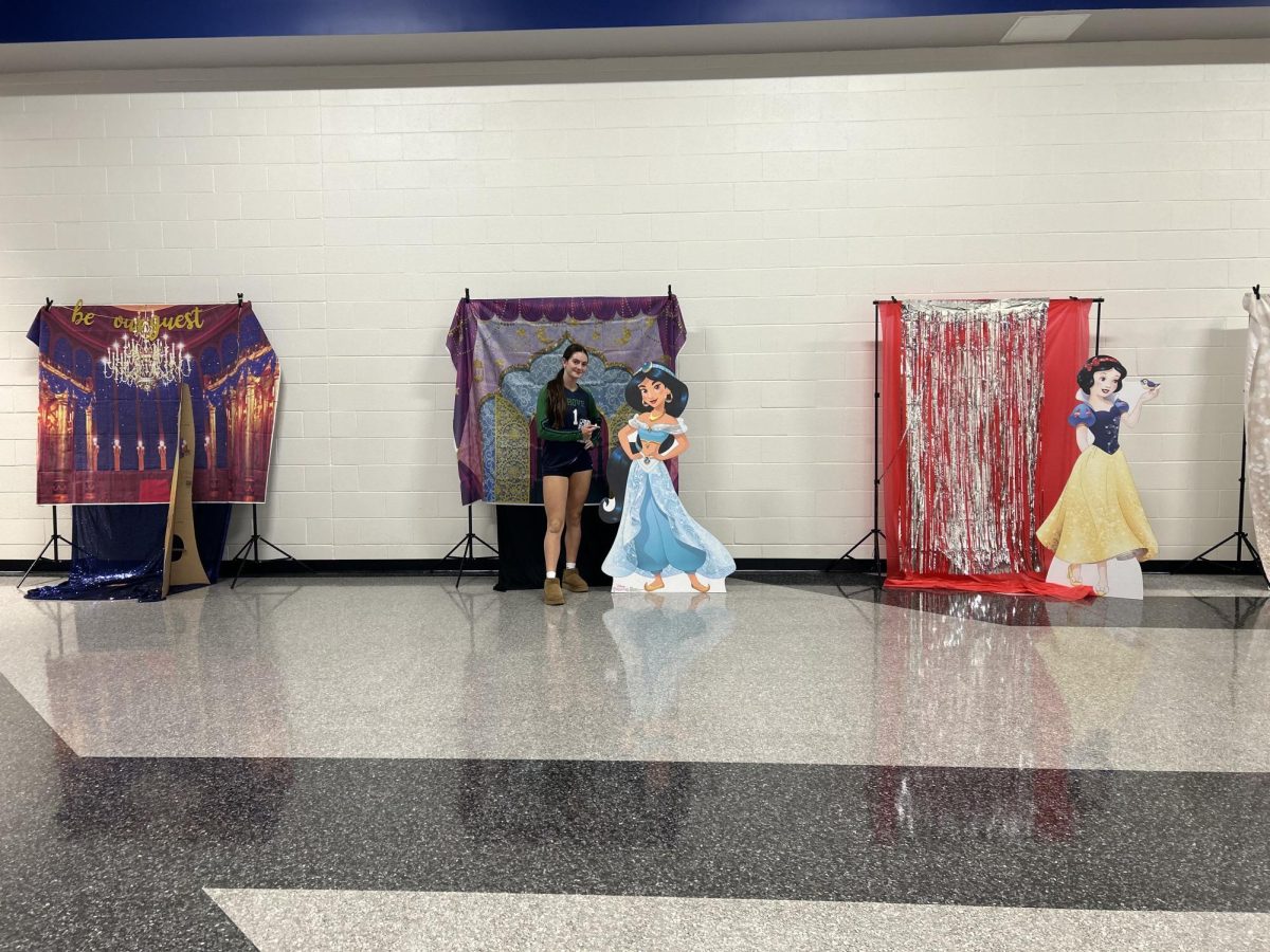 SCA props up homecoming decorations in main hallway. 