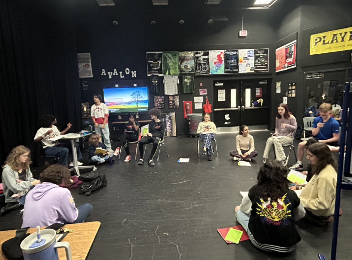 Excalibur meeting on Sep. 9, students are sitting in a circle as they read through the script.
