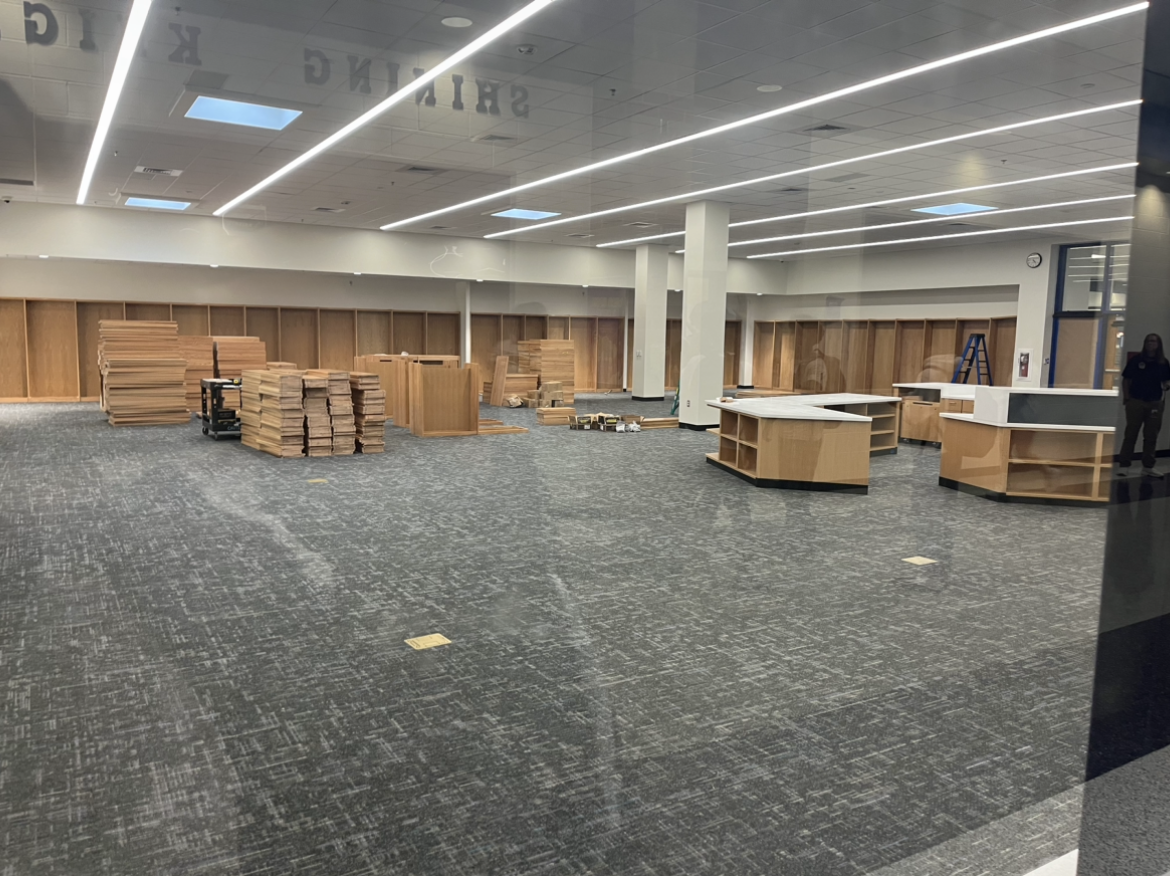 Bookshelves in the new library waiting to be assembled late Friday night Sep. 20 in John Champe's Main Hallway. Contractors will put them together to hold books that will be added soon.