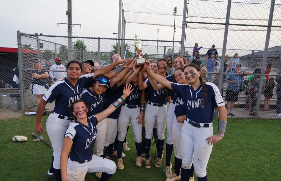The lady knights hold up the district win trophy. They worked hard to win each district game. 