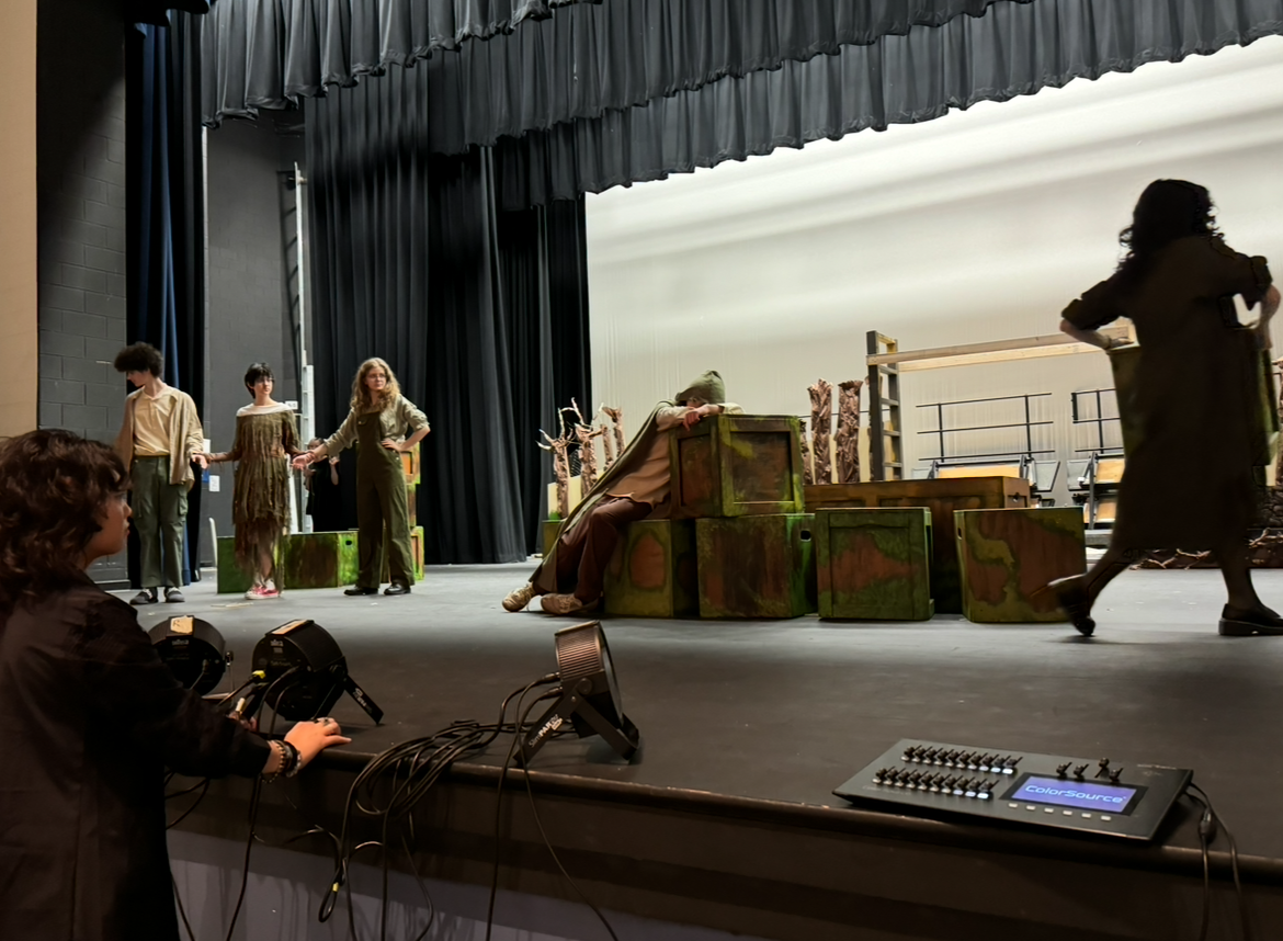 Actors in the Excalibur travel theater team rehearsing their production, Rue, with recently added costumes and microphones on Oct. 22 in the JCHS auditorium on stage. Actors rehearse with microphones and costumes to get used to them before their show date.
