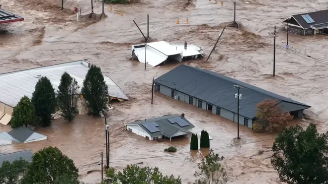 Houses left swallowed by the flood left after the storm. All sorts of rubble and debris flow throughout the waters. (Photo courtesy of USA Today)
