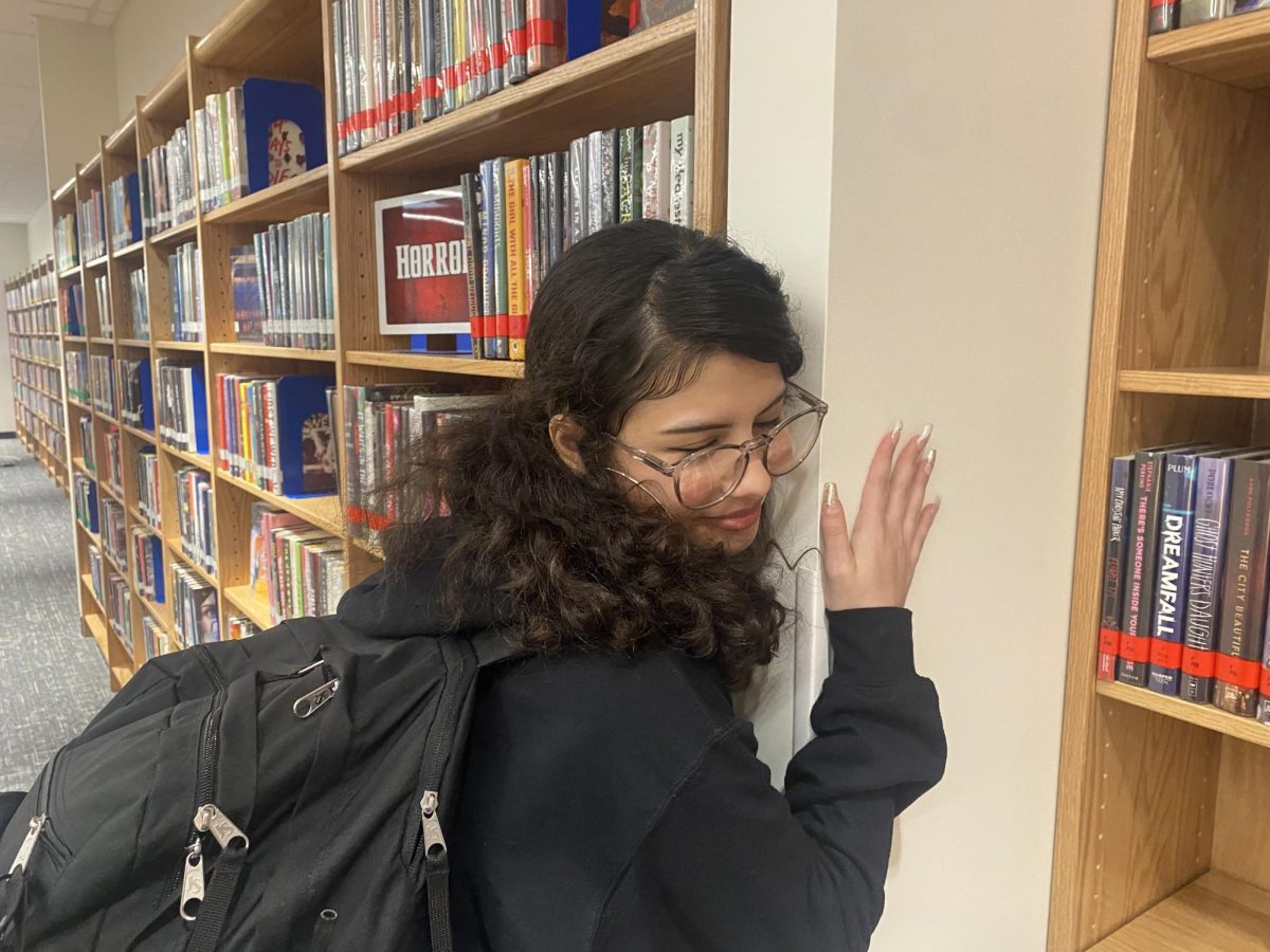 This photo is a demonstration of what couples at Champe do in the hallways. Elisha DiCapua is acting out what she sees in the hallways that make her feel very uncomfortable and grossed out. 