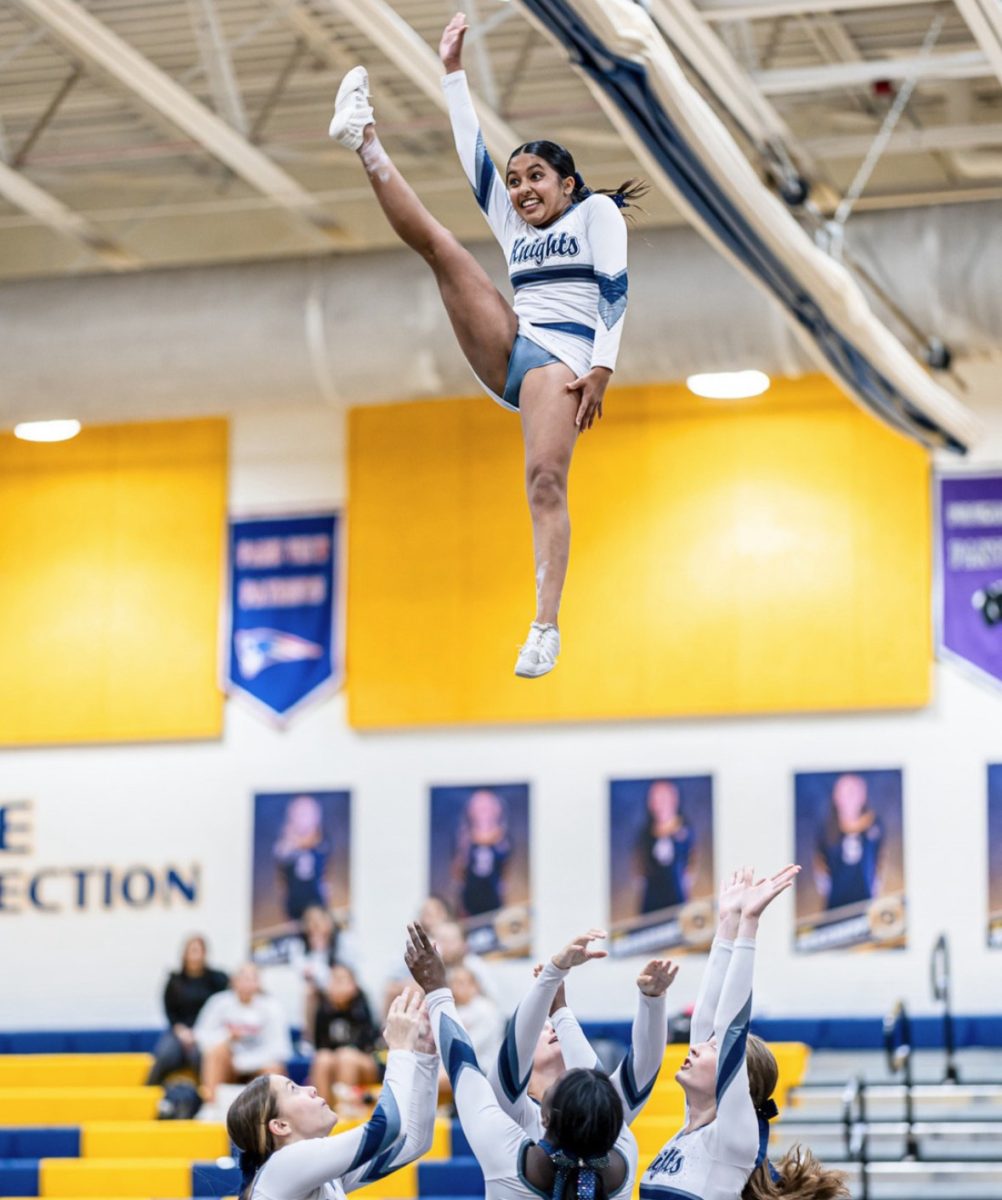 Varsity Cheerleader Riya Chauhan flying for the John Champe Knights. The Knights were competing in the Loudoun County Mini DIstrict. 