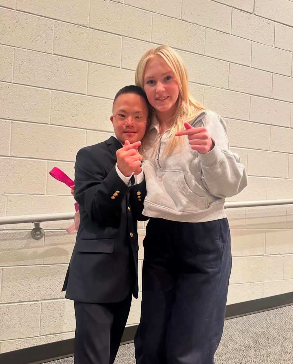 Junior Danica Eklund taking a picture with Aiden after his performance. 