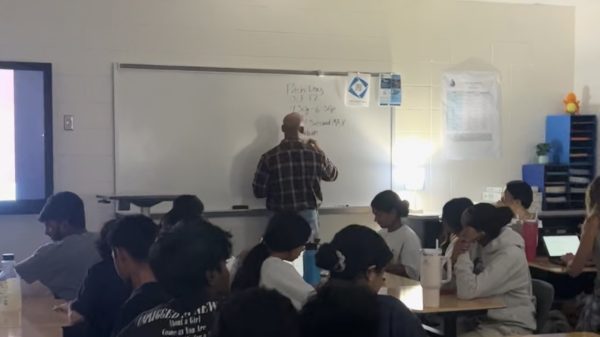 Marketing teacher and DECA advisor, Patrick Lucas, educating his students on the importance of a business' unique value proposition (UVP). Lucas emphasized this necessary component for success and profitability that was part of a business research unit. 