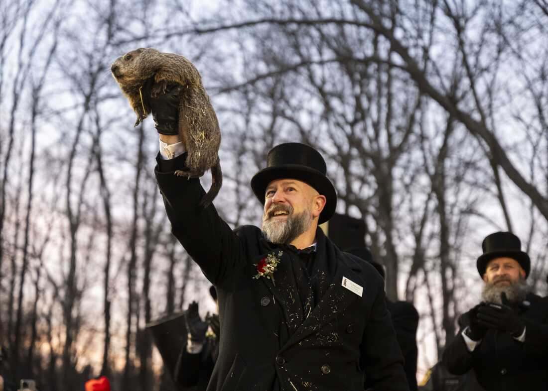 A.J. Dereume, a handler from the Groundhog Club, holds Punxsutawney Phil during the 139th Groundhog Day celebration at Gobbler’s Knob in Punxsutawney, Pennsylvania (Photo Courtesy of NPR).