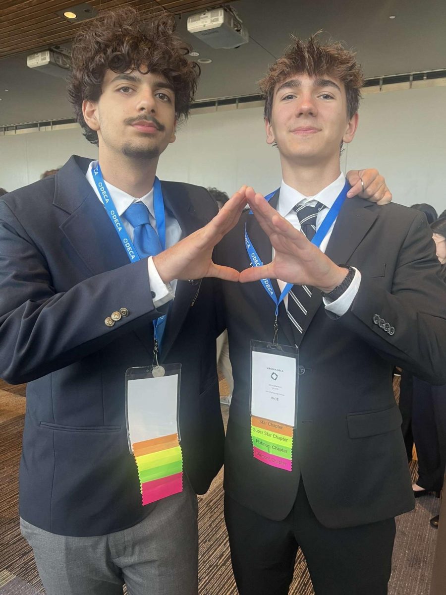 DECA members Mahmoud Khatab and Jacob Dawson standing in the Virginia Beach Conference Hall. Over 5,000 students gathered to attend this three day conference and competed for spots at ICDC.