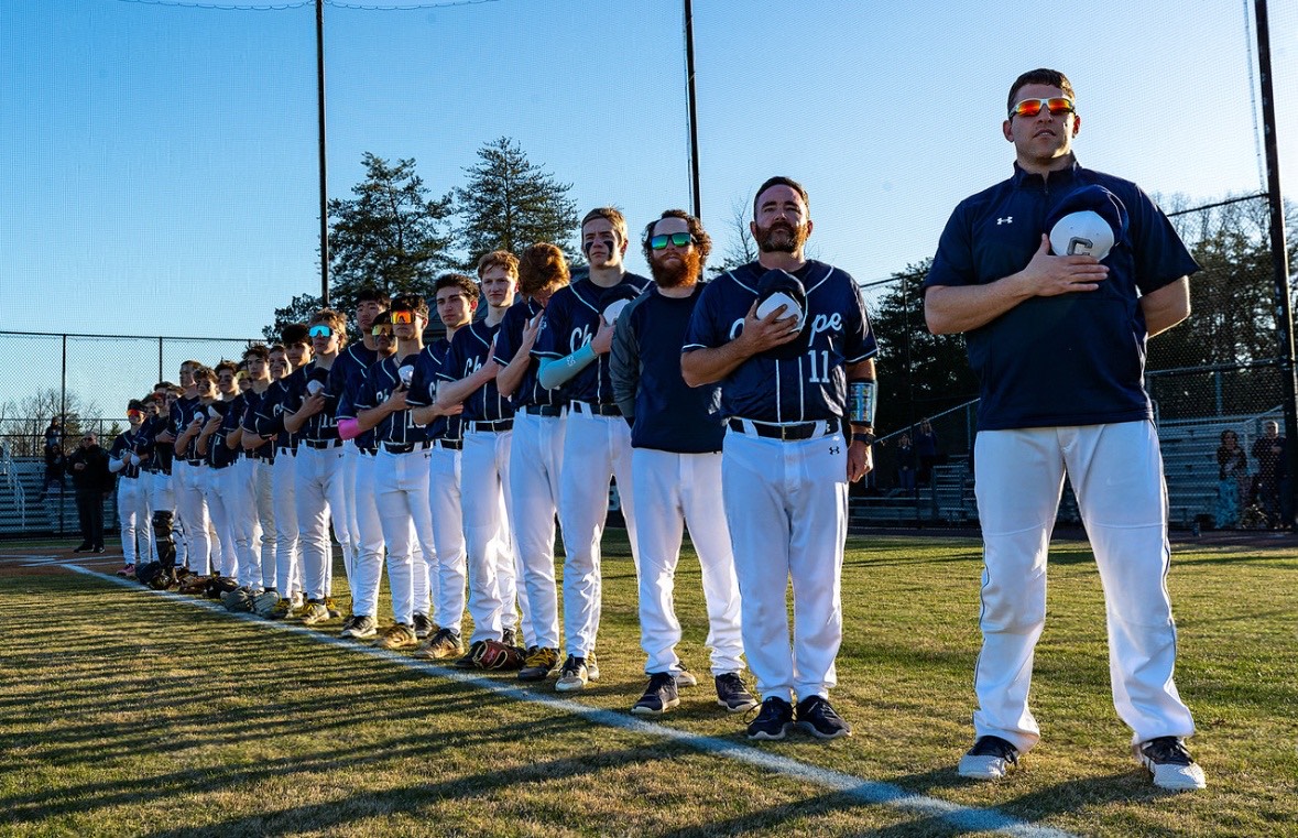 The Knights are lined up for the national anthem. The Knights game was going to start after the anthem finished. 