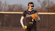 Freshman varsity softball pitcher, receiving pitch call from the coach. The coach called the pitch so she knew what to throw. 