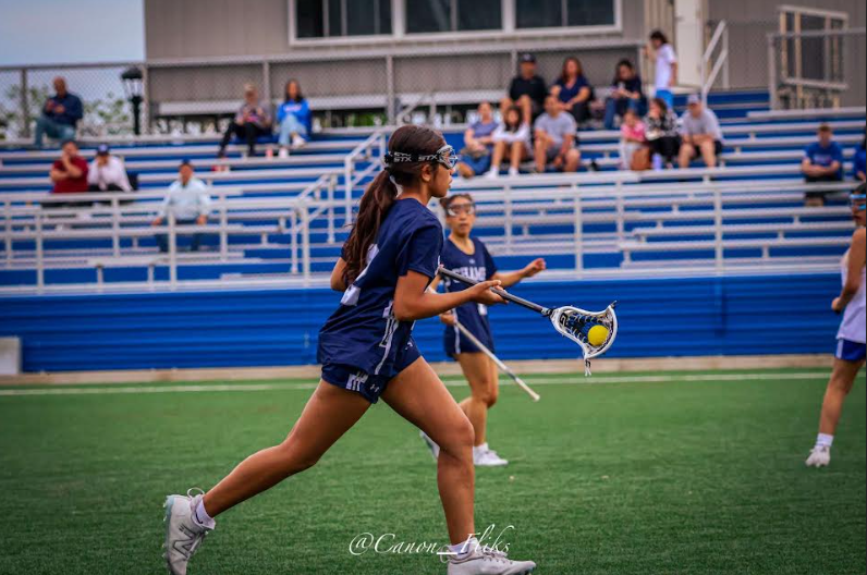 Varsity player Kareena Ohri cradling the ball. Ohri was part of the Knights victory against Park View. 