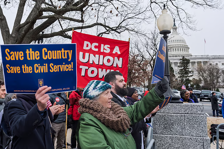 Civil service workers and activists protest the policies of President Donald Trump and Elon Musk outside the Capitol in Washington, Tuesday, Feb. 11, 2025
