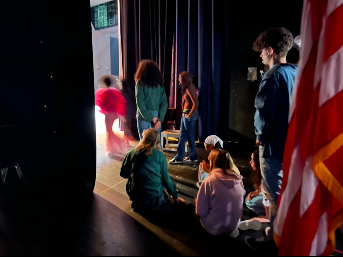 Actors waiting backstage for cues to go on during the production of Friday Knight Live Jun. 6, 2025 in the John Champe High School auditorium. Astors wait in the wings of a stage when they are not in a scene during a production.