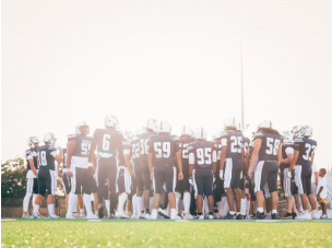  John Champe varsity football team in a huddle before the game starts. 